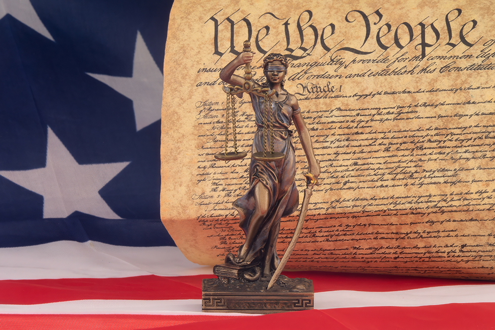 We The People document behind a small statue
