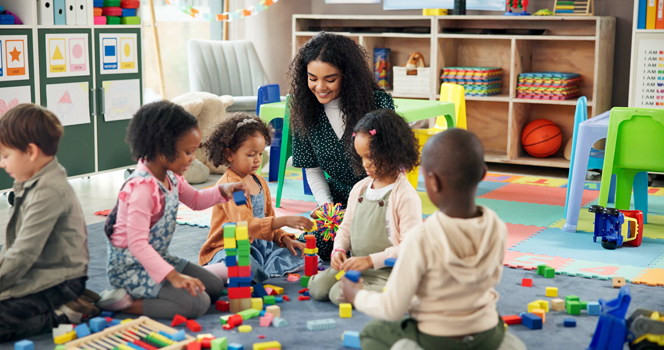 Teacher in a classroom with kids playing