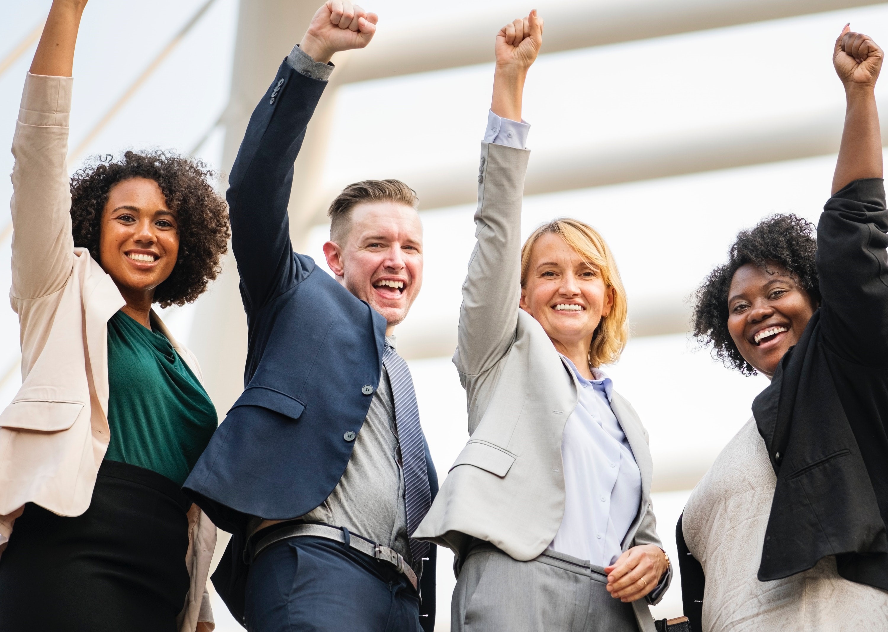 Adults celebrating with their hands in the air