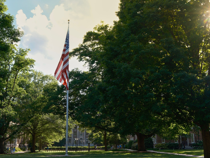 American flag waving in a vibrant park setting at Chapel Hill, North Carolina
