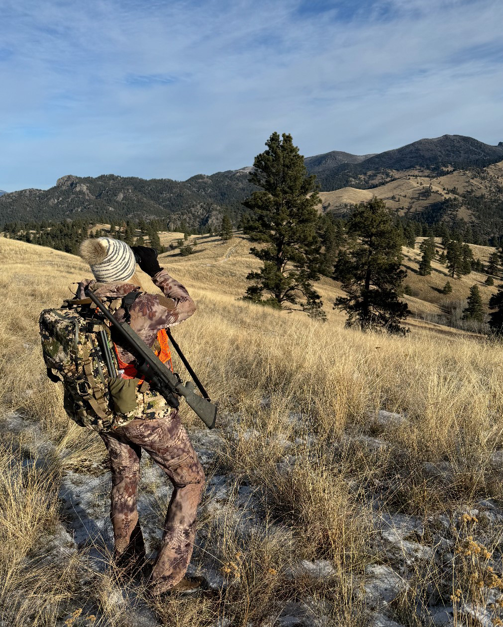 Superintendent Hedalen hunting, glassing an open range