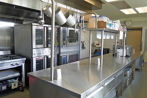 Industrial Kitchen showing a stove, bread and other ovens, and food prep area