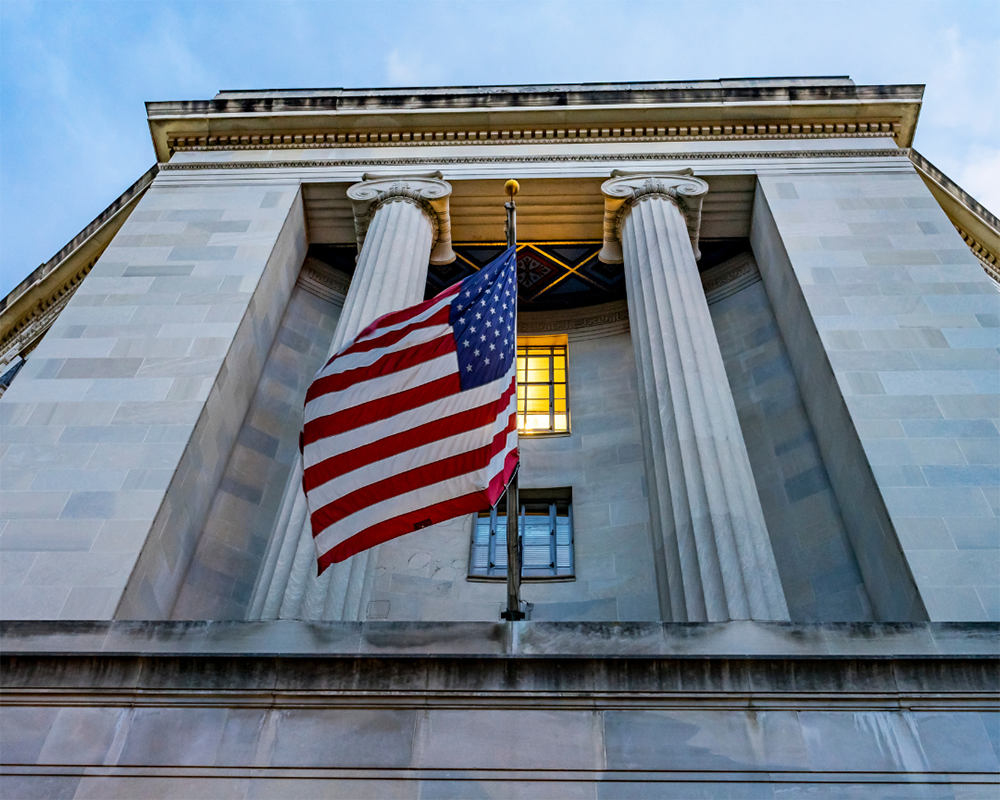 Concrete Building with pillars and an American flag