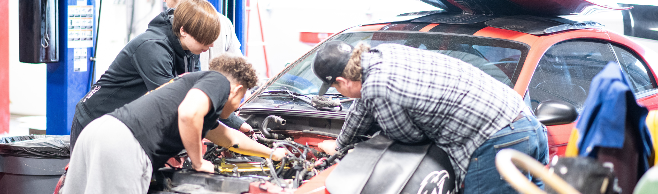 Kids working on a car